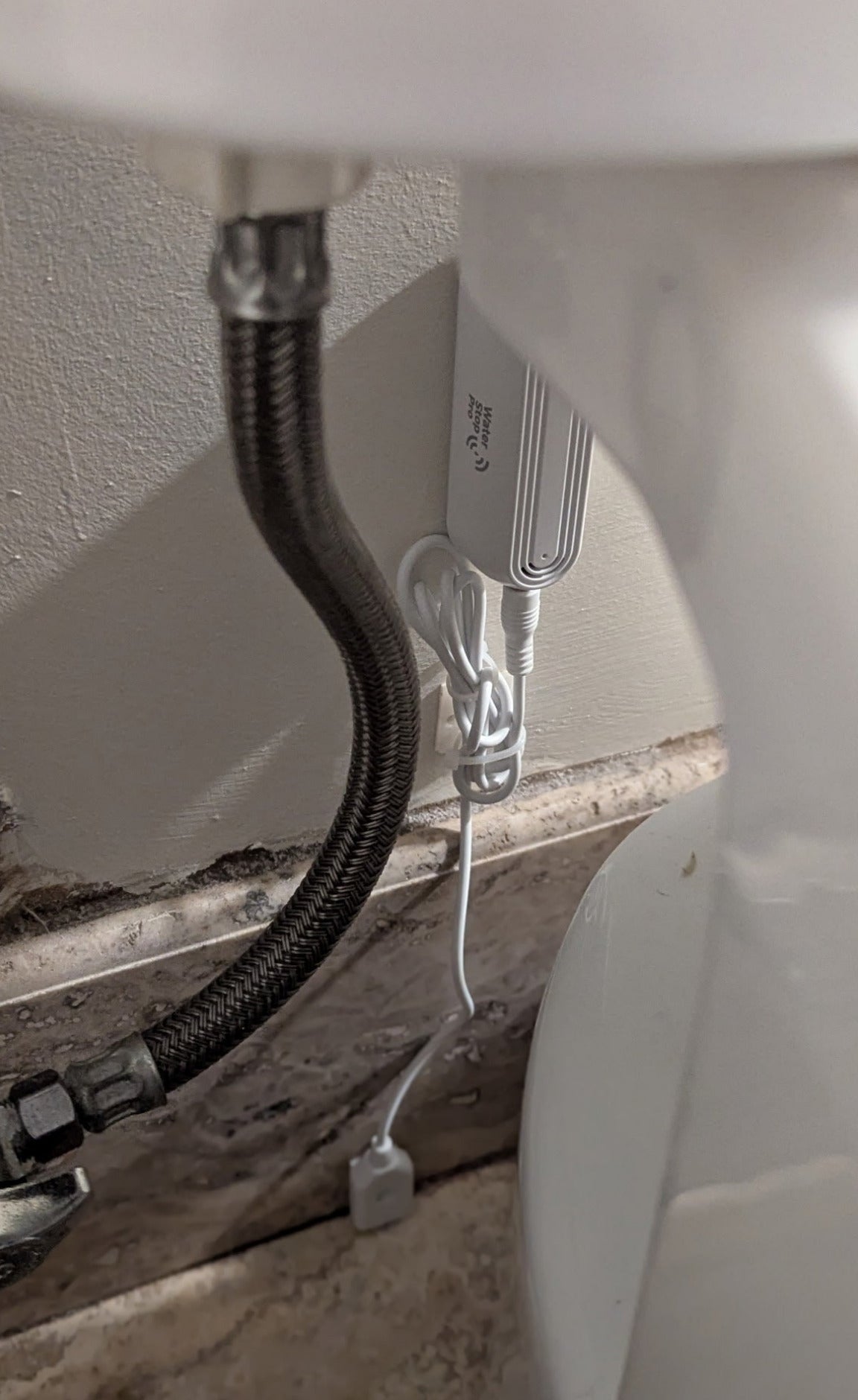 Close-up of probe sensor installed behind toilet
